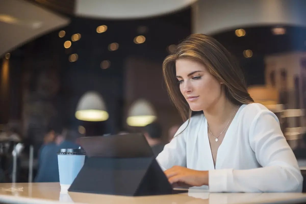 Young businesswoman in a cafe using tablet Young businesswoman in a cafe using tablet